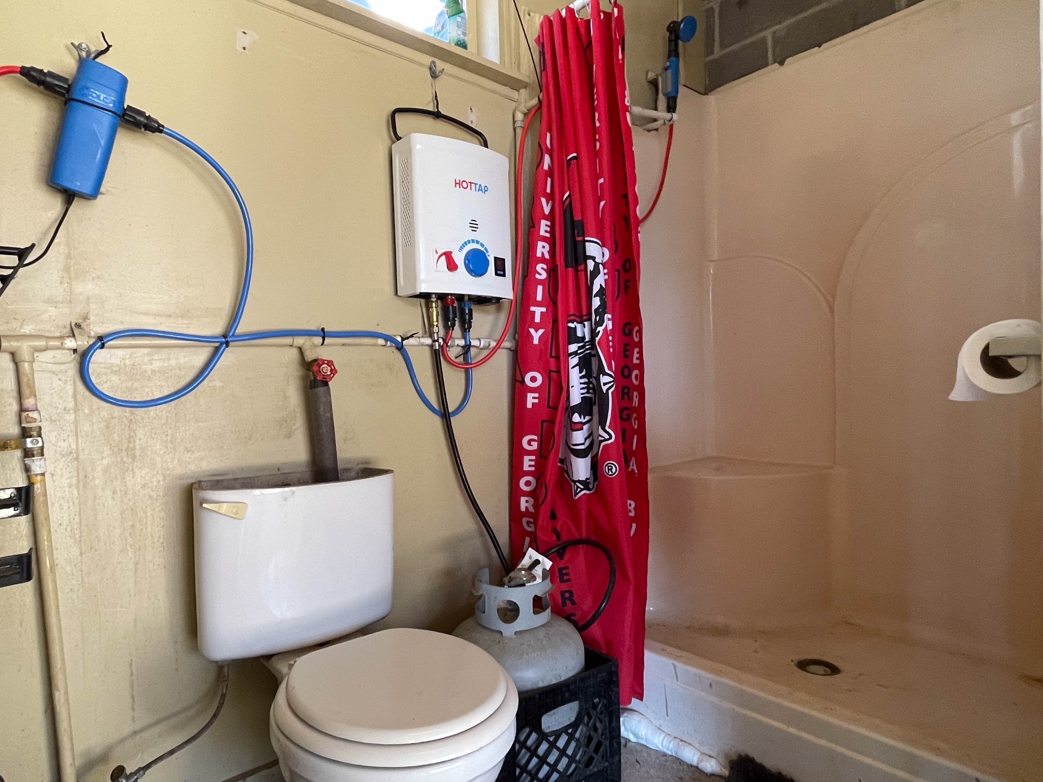 1722 Park Road Holladay, TN 38341 - Photo 49 of 52 a white toilet sitting next to a bathroom sink and a mirror