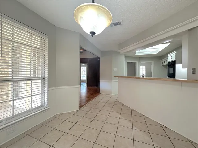 a large kitchen with cabinets and stainless steel appliances