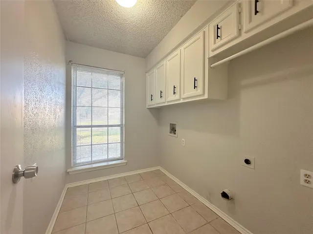 a view with granite countertop white cabinets and a sink