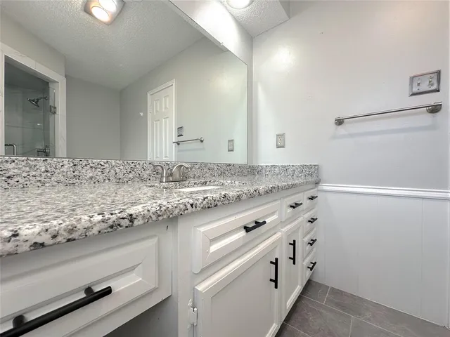 a view of an empty room and a ceiling fan