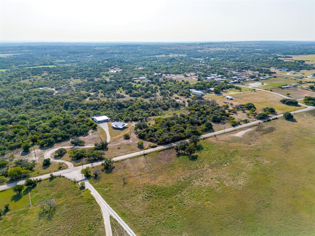 8310 Prather Road Springtown, TX 76082 - Photo 12 of 13 an aerial view of residential houses with outdoor space and trees