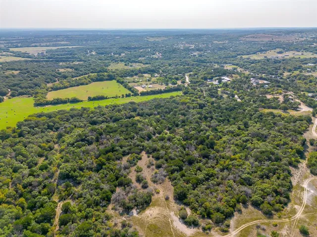 an aerial view of residential houses with outdoor space and swimming pool