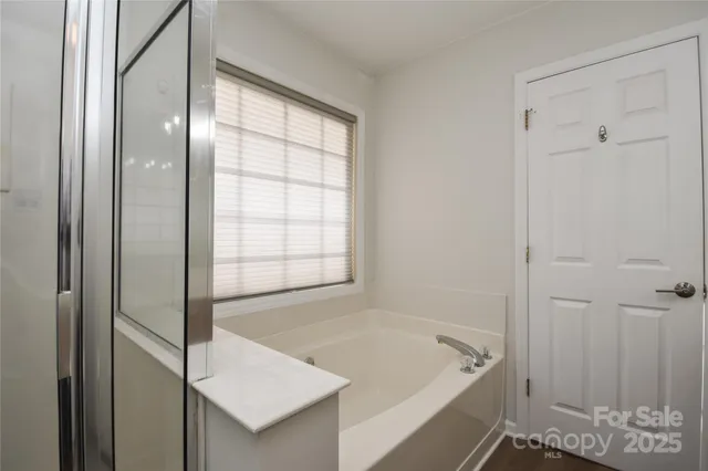 a bathroom with a tub and shower