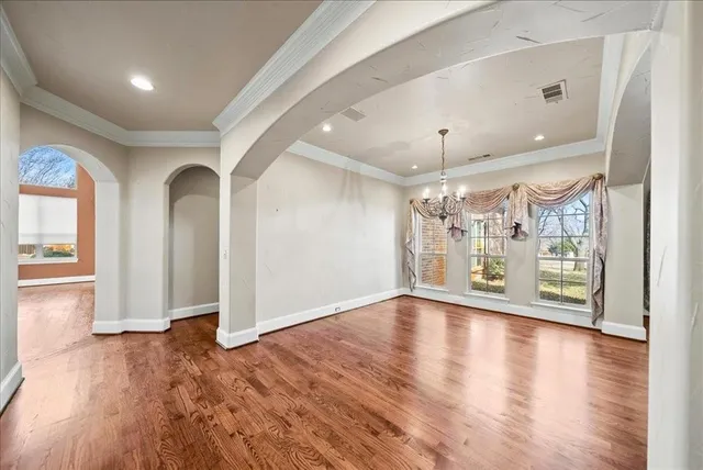 a view of a big room with wooden floor windows and fireplace