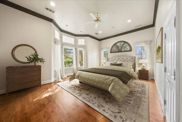 a view of an empty room with a window and a ceiling fan