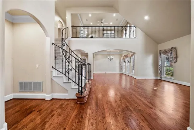 a living room with furniture or chandelier and a wooden floor