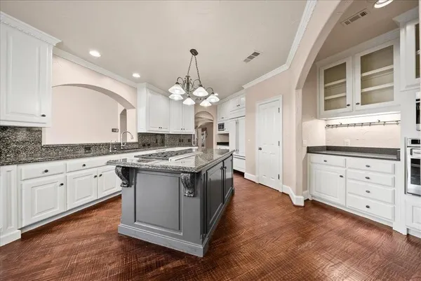 a kitchen with stainless steel appliances granite countertop a stove and a center island