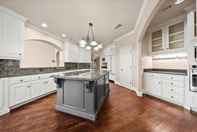 a kitchen with stainless steel appliances granite countertop a stove and a center island