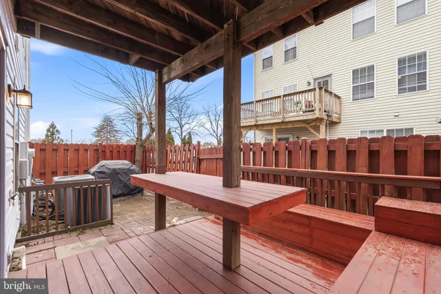 a view of balcony with wooden floor and seating space