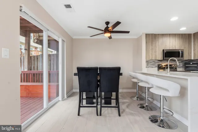 a view of a dining room with furniture and a window