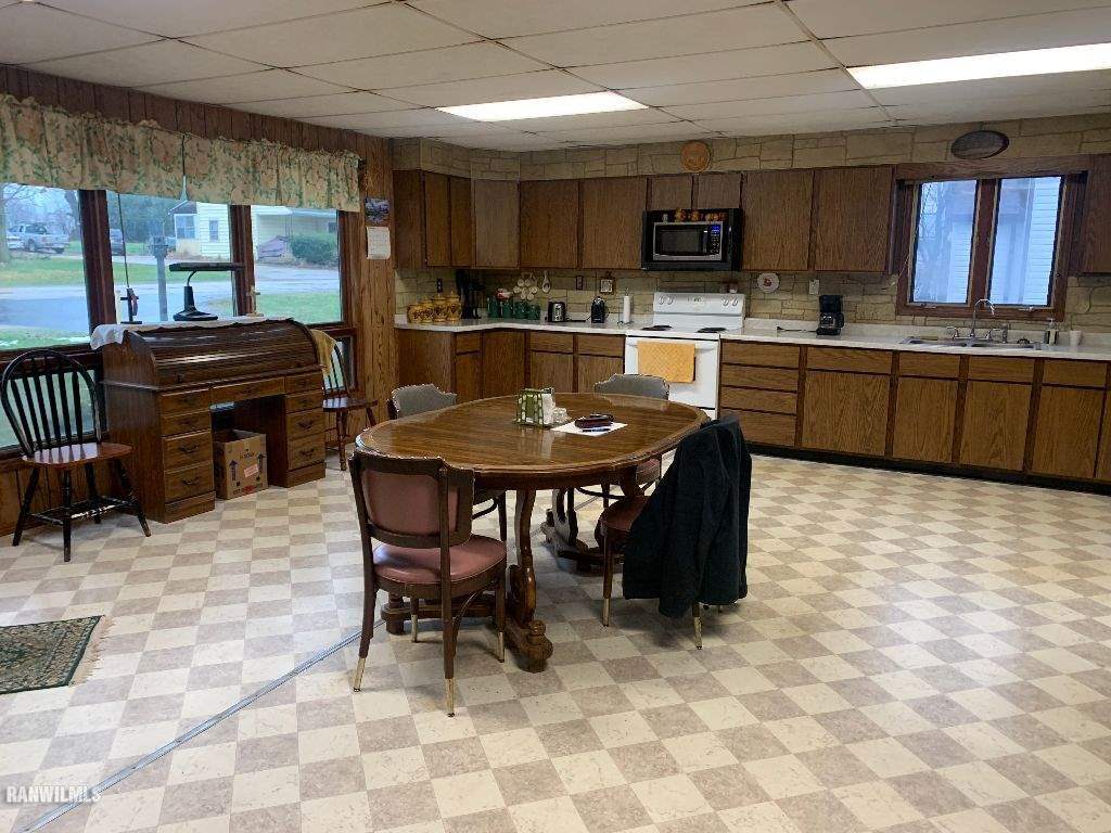 2708 West Florence Road Freeport, IL 61032 - Photo 8 of 16 a kitchen with stainless steel appliances a stove a sink a table and chairs