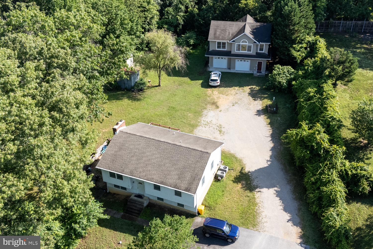 an aerial view of a house with a yard basket ball court and outdoor seating