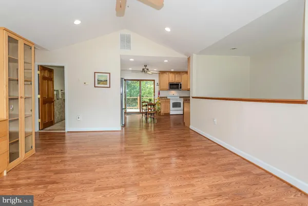 a view of a living room and kitchen with a sink