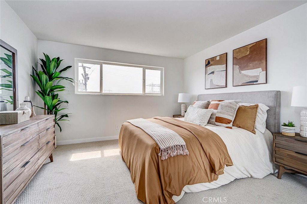 770 West Imperial Avenue, Unit 87 El Segundo, CA 90245 - Photo 16 of 29 a bedroom with a large bed and a potted plant