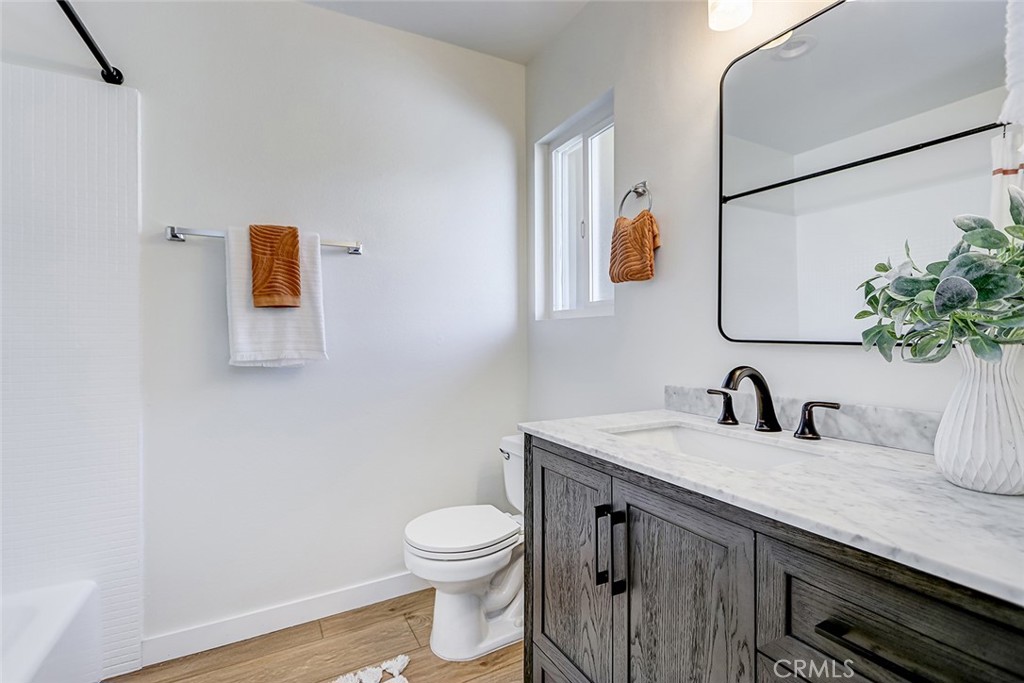 770 West Imperial Avenue, Unit 87 El Segundo, CA 90245 - Photo 17 of 29 a bathroom with a granite countertop sink a toilet and mirror