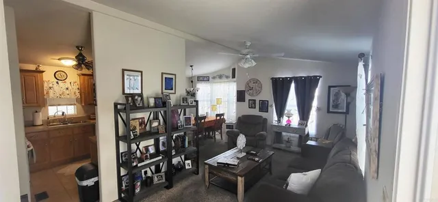 a living room with lots of furniture and refrigerator