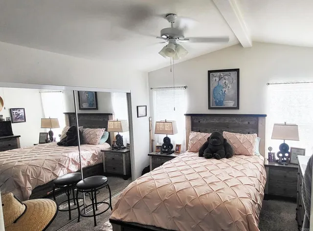 a bedroom with a bed and ceiling fan