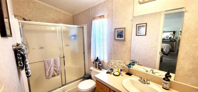 a bathroom with a sink toilet and shower