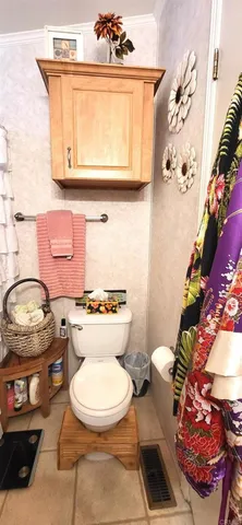 a bathroom with a toilet a sink and a mirror