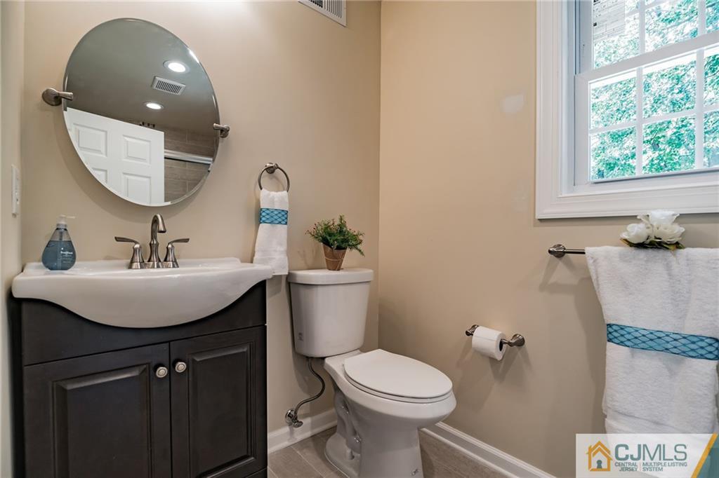 8 Dayton Road Edison, NJ 08817 - Photo 14 of 25 a bathroom with a sink toilet and a mirror