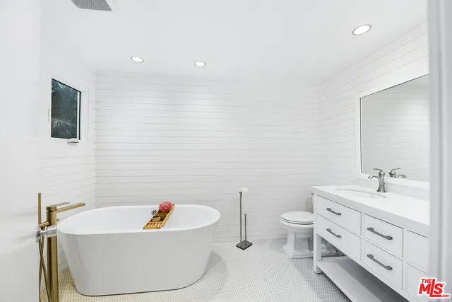 a bathroom with a toilet a sink and bathtub