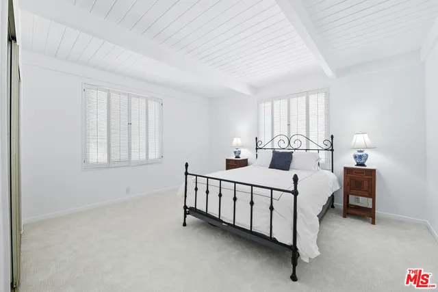 a bed room with a bed and a night stand