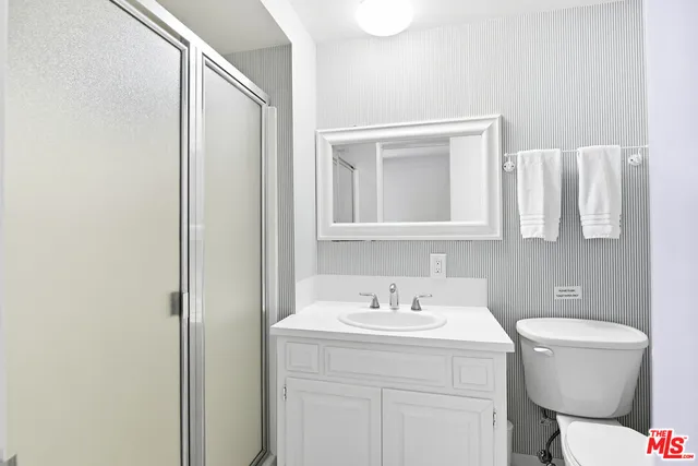 a bathroom with a sink toilet and mirror