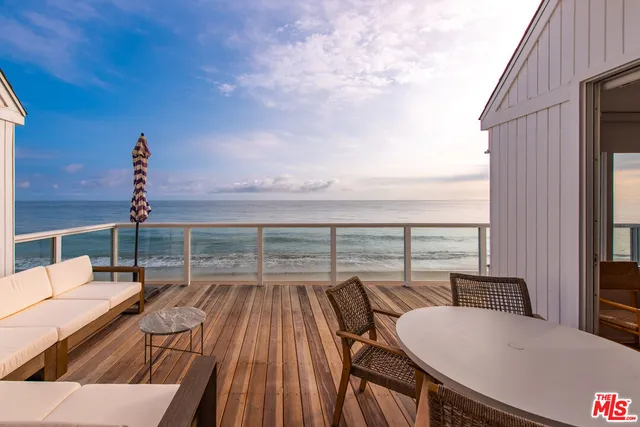 a balcony with furniture and city view