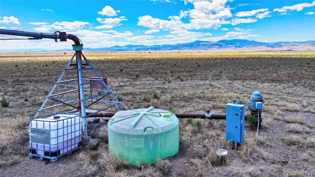a view of a swimming pool with a table & chairs