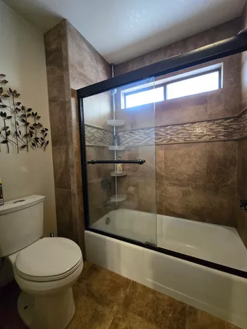 a bathroom with a toilet and a shower