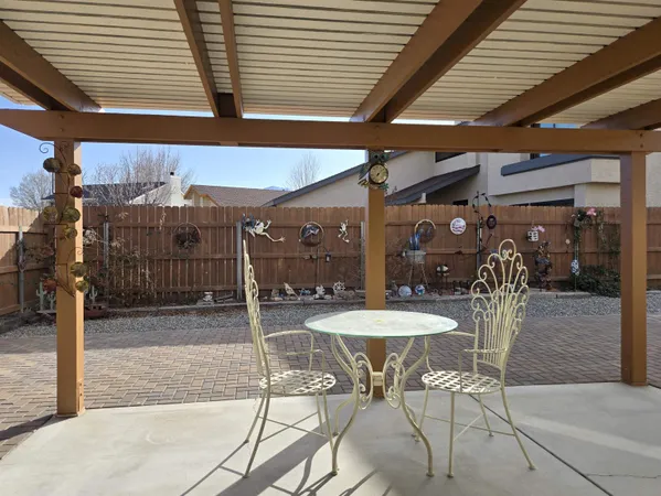 a view of a patio with a table and chairs and potted plants