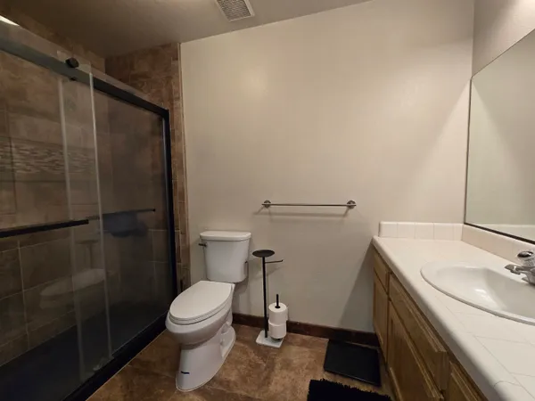 a bathroom with a sink toilet and shower