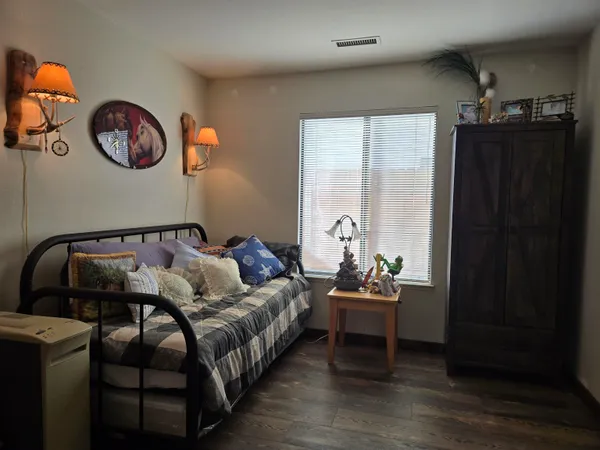 a bedroom with a bed and a window