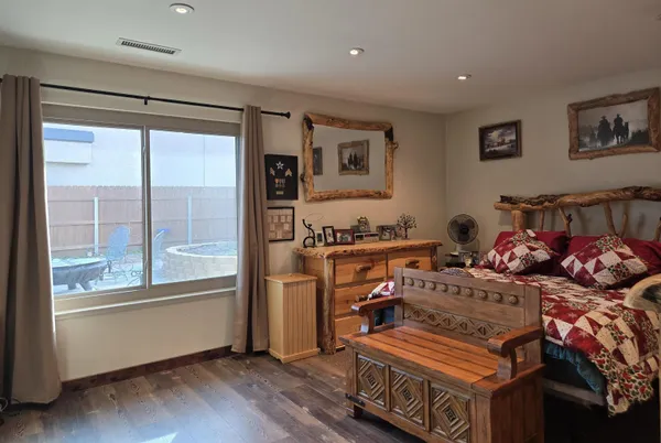 a bedroom with furniture and a window