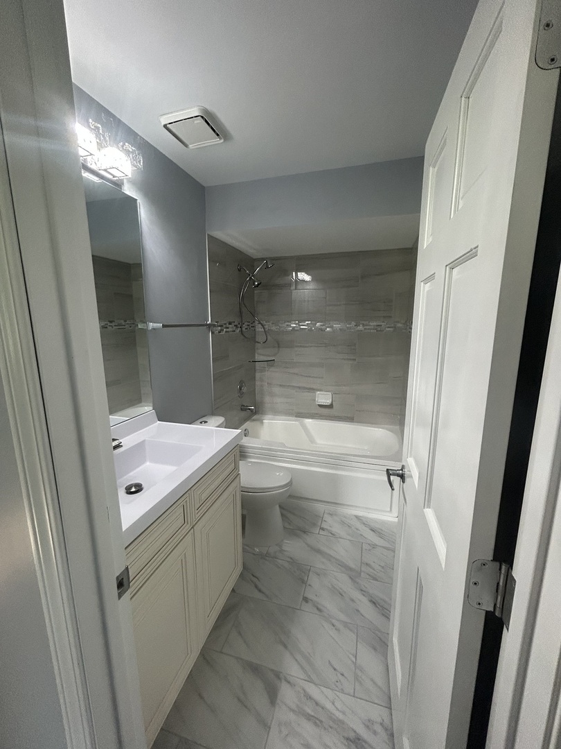 32-w320 Montgomery Road Aurora, IL 60504 - Photo 18 of 37 a bathroom with a double vanity sink and mirror