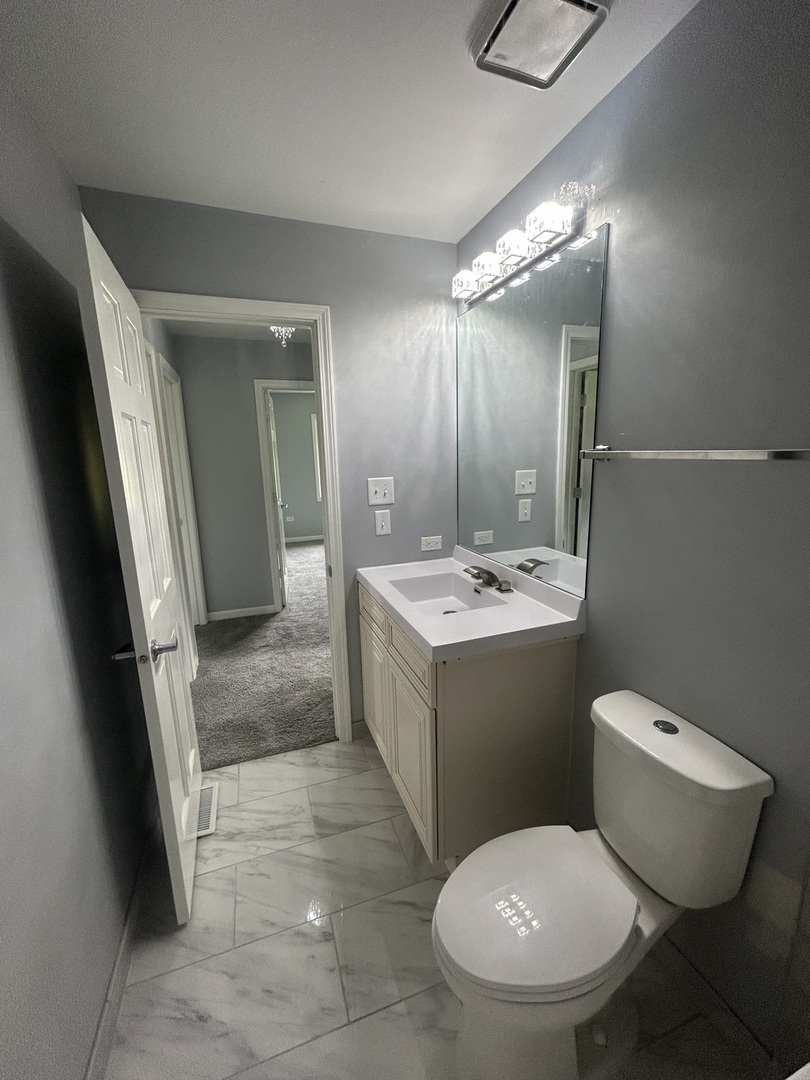 32-w320 Montgomery Road Aurora, IL 60504 - Photo 20 of 37 a bathroom with a toilet sink and mirror