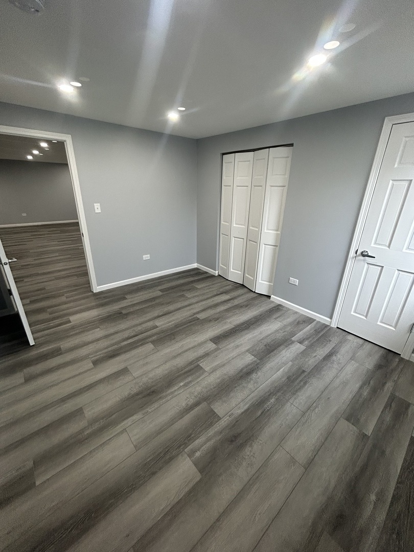 32-w320 Montgomery Road Aurora, IL 60504 - Photo 36 of 37 an empty room with wooden floor and windows