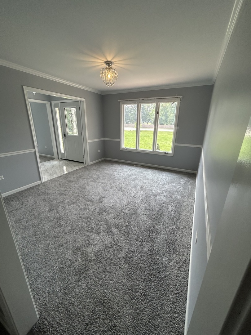 32-w320 Montgomery Road Aurora, IL 60504 - Photo 9 of 37 a view of an empty room with window and chandelier