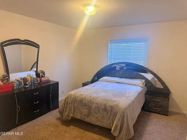 a bedroom with a bed and dresser