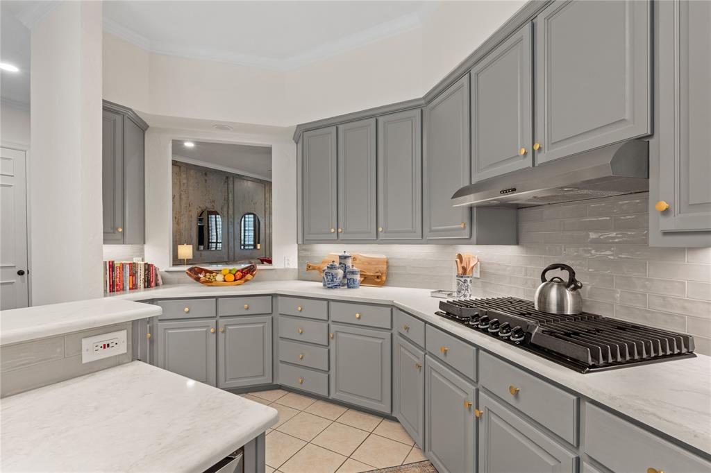 102 Weatherly Circle Rockwall, TX 75032 - Photo 14 of 39 a kitchen with sink a stove and cabinets