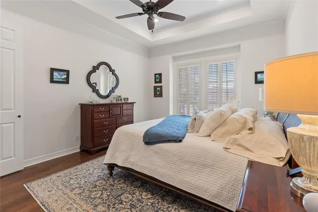 a bedroom with a bed and a table with wooden floor