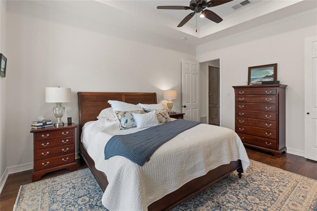 102 Weatherly Circle Rockwall, TX 75032 - Photo 18 of 39 a bedroom with a bed and a dresser