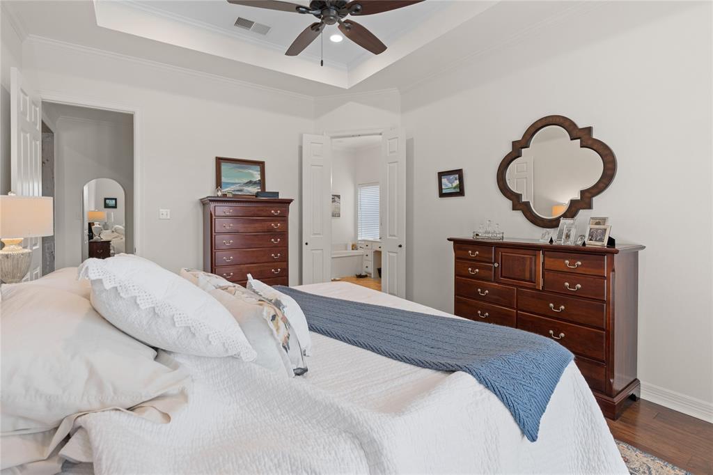 102 Weatherly Circle Rockwall, TX 75032 - Photo 19 of 39 a bedroom with a bed and a dresser