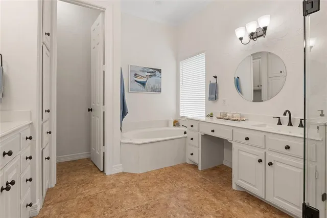 a bathroom with a tub sink and shower