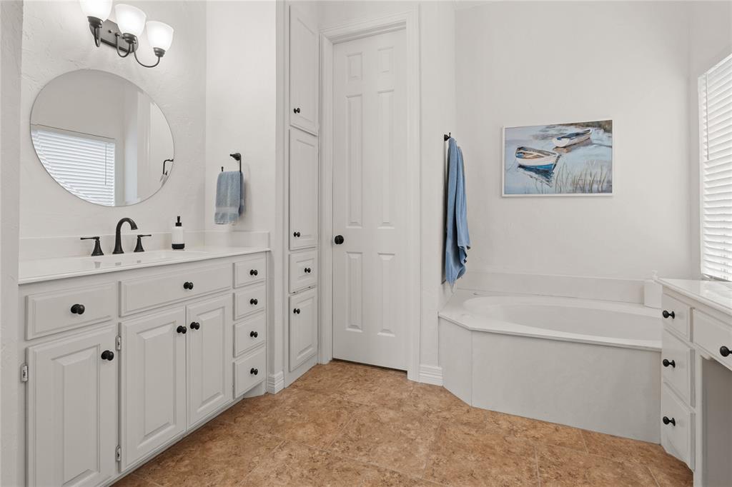 102 Weatherly Circle Rockwall, TX 75032 - Photo 22 of 39 a bathroom with a tub sink and mirror