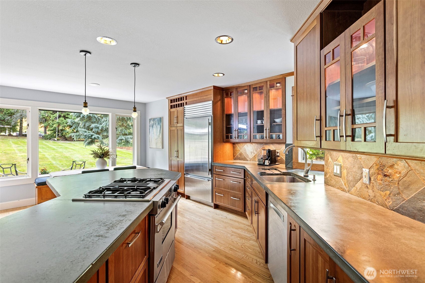 22126 53rd Avenue Southeast Bothell, WA 98021 - Photo 10 of 40 a kitchen with stainless steel appliances granite countertop a stove a sink and a wooden floors