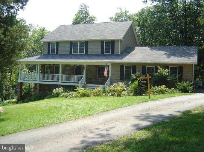 2888 Barrick Road Finksburg, MD 21048 - Photo 2 of 29 a front view of a house with a yard and potted plants