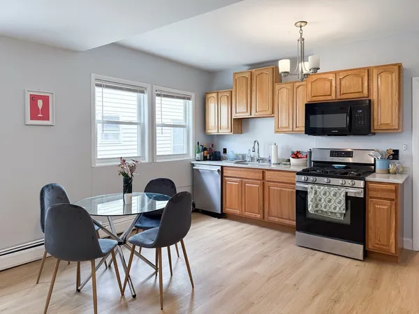 a kitchen with a dining table and chairs