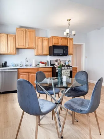 a kitchen with a dining table and chairs