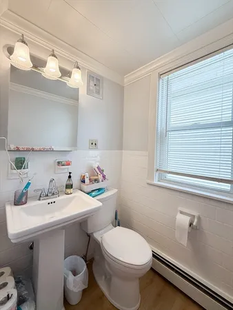 a bathroom with a sink mirror and toilet